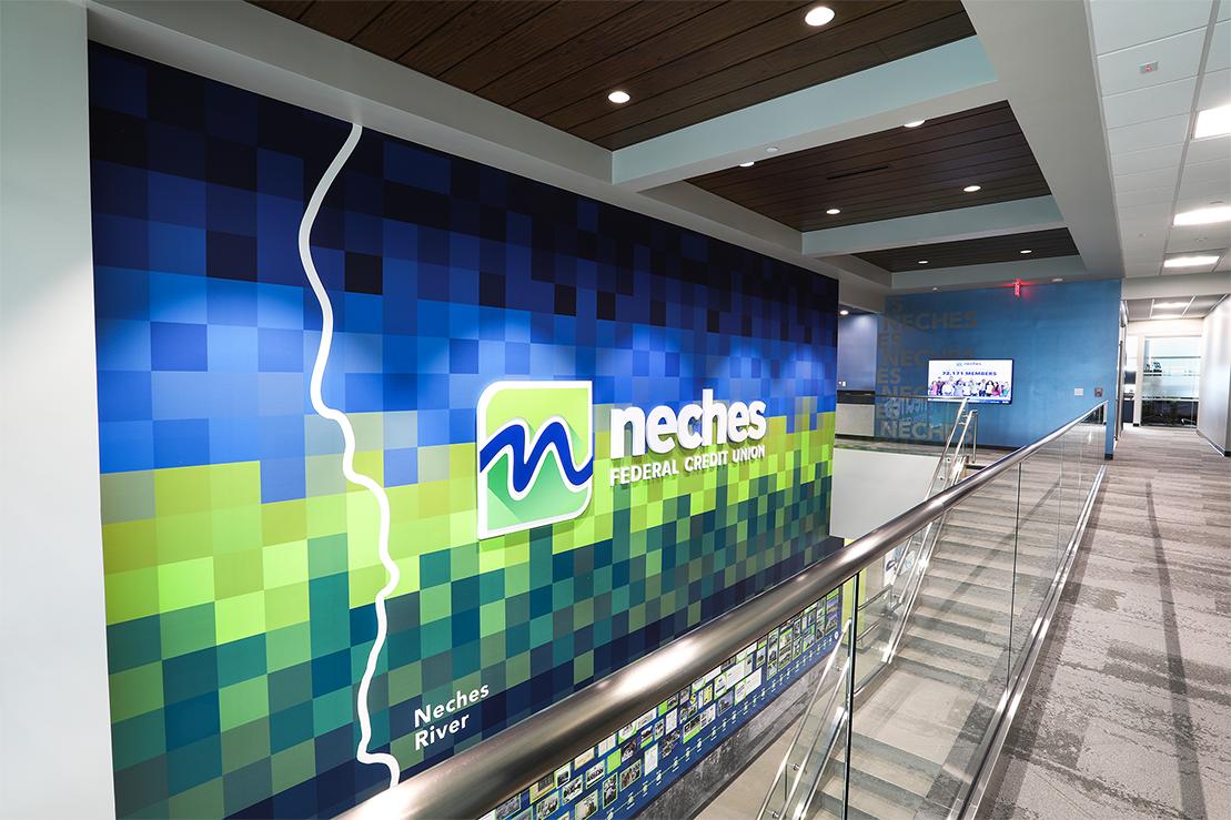 Neches Federal Credit Union stairwell with brightly branded wall