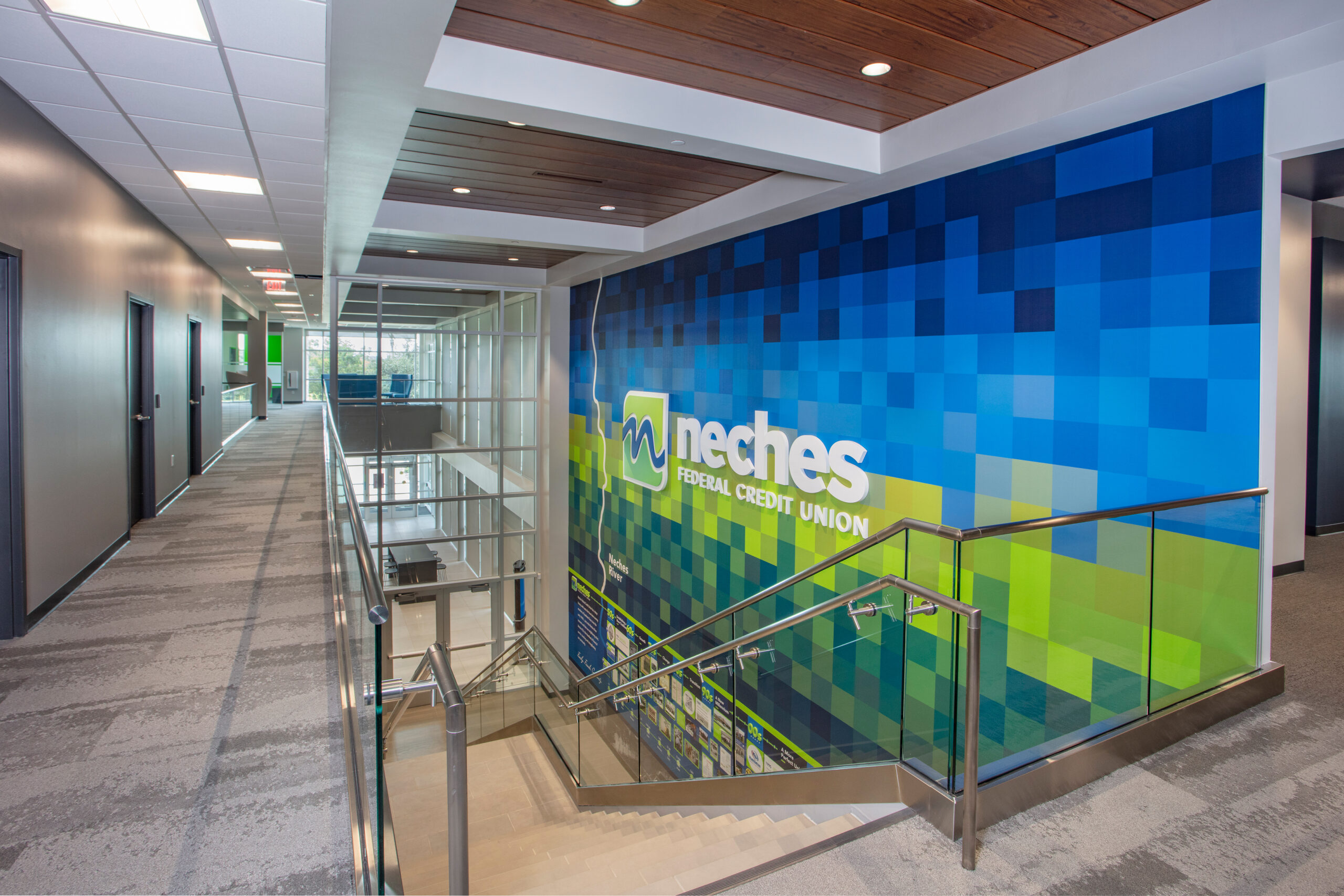 stairs and mural wall in Neches Federal Credit Union building