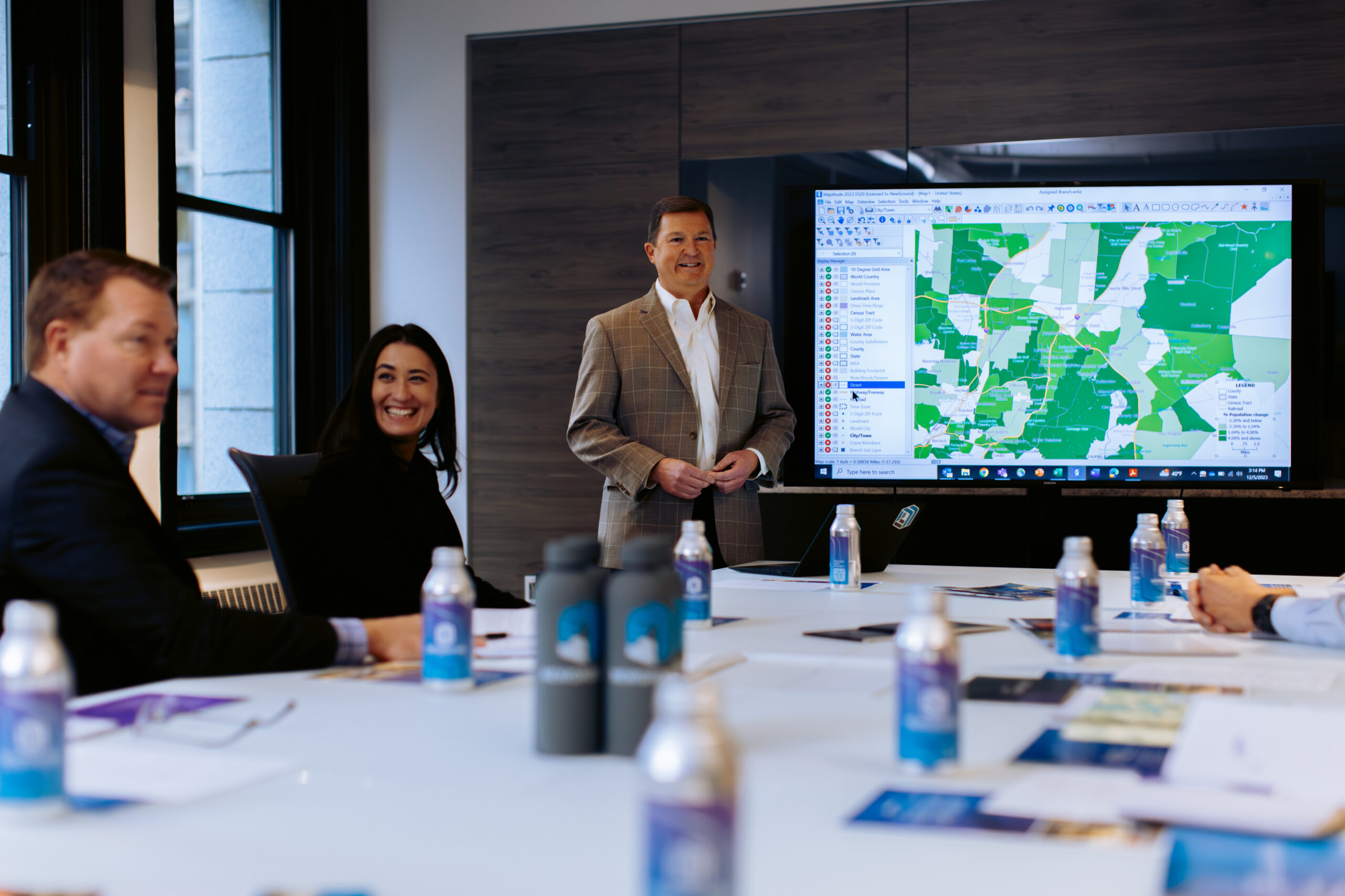 conference room table with a few team members sitting around it talking about growth strategies