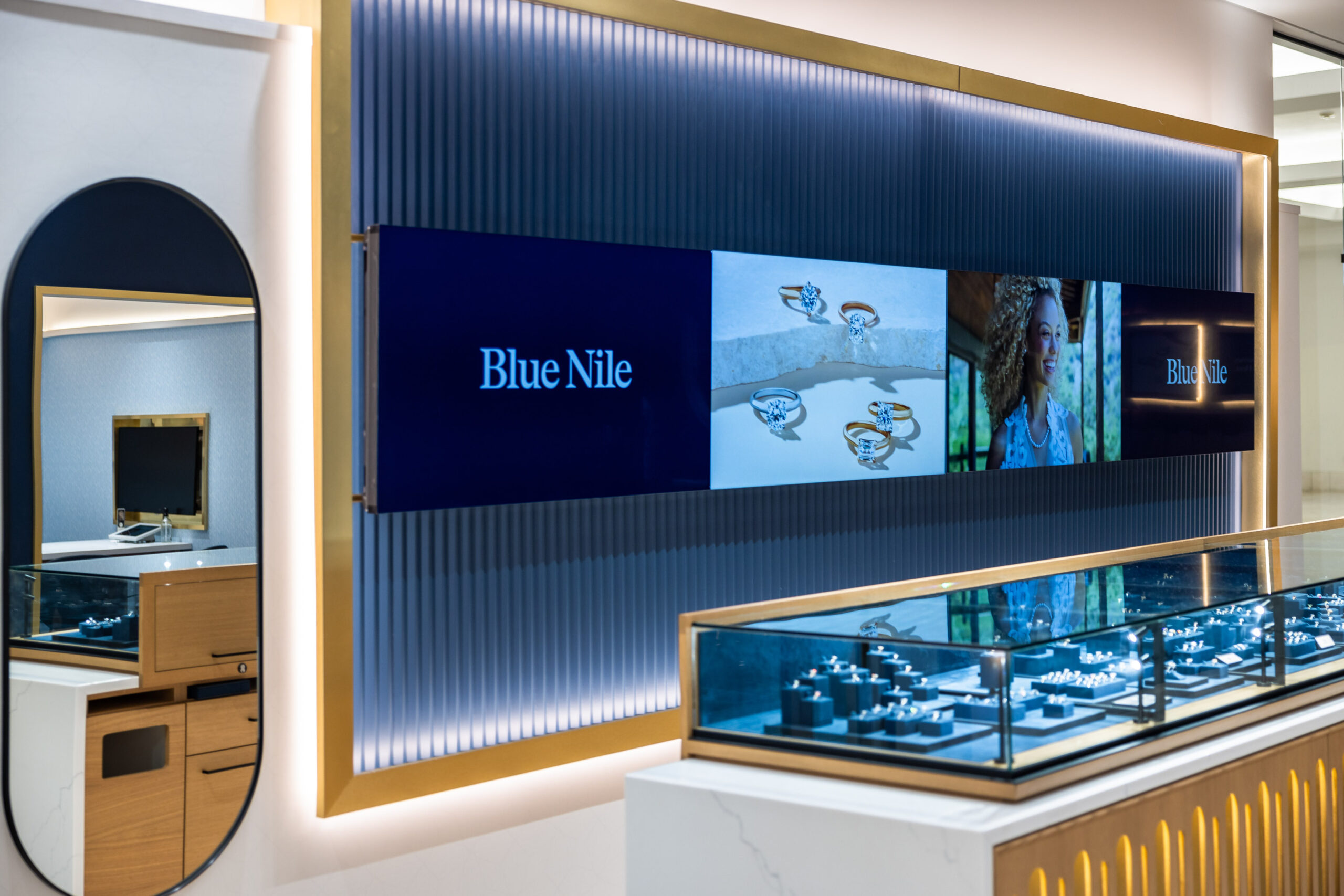 Blue Nile sign on the wall and jewelry case in the foreground