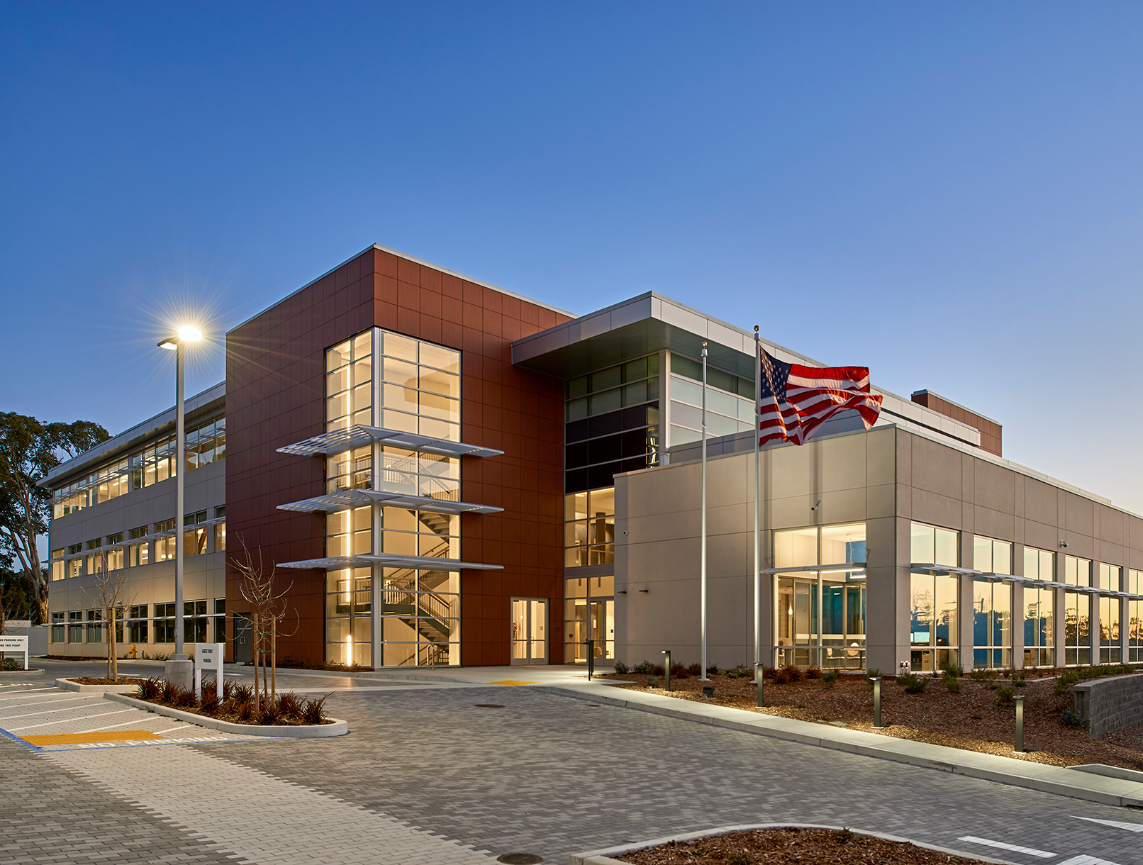 newly constructed building with flag flying in front