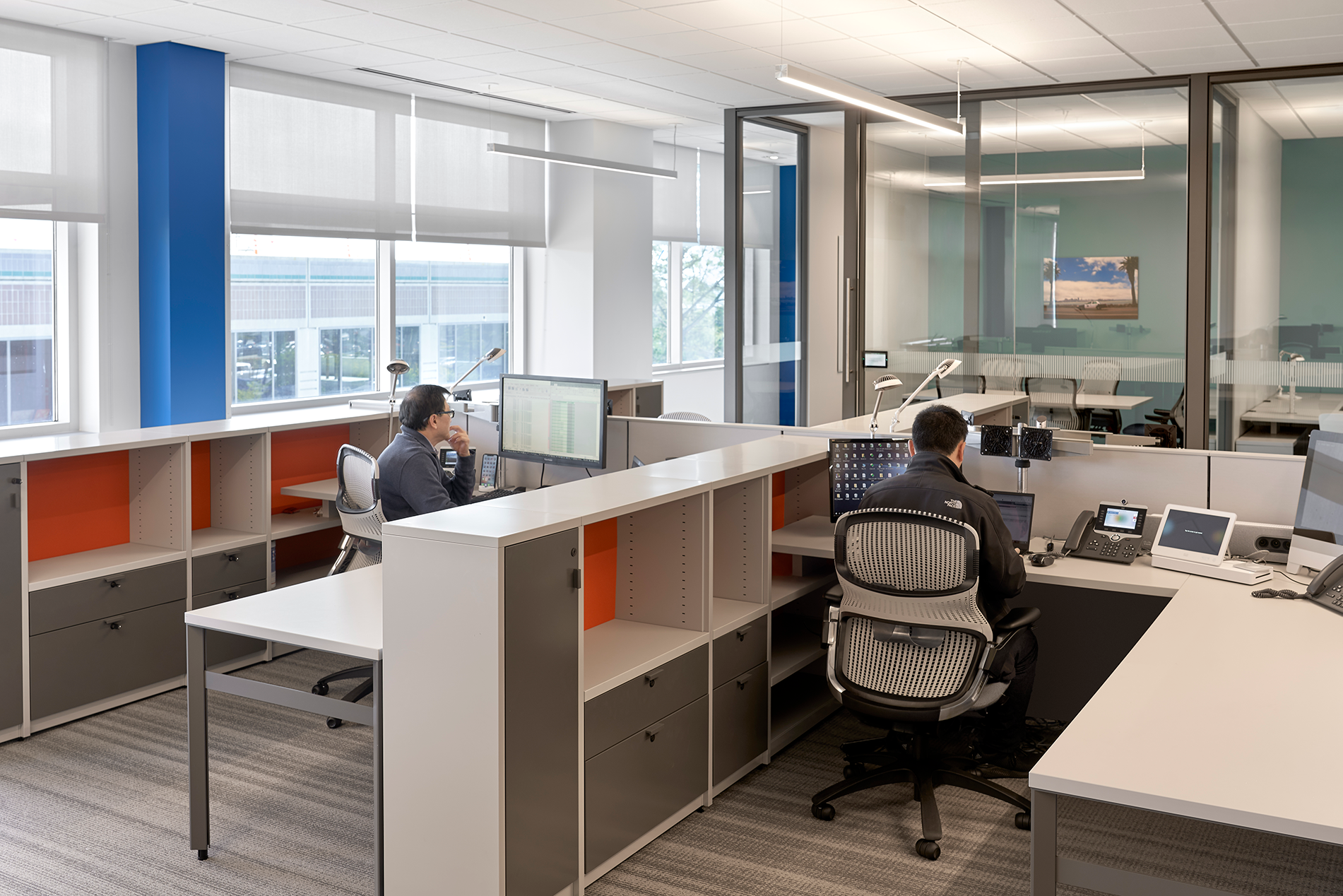 workspace with 2 men sitting at desks