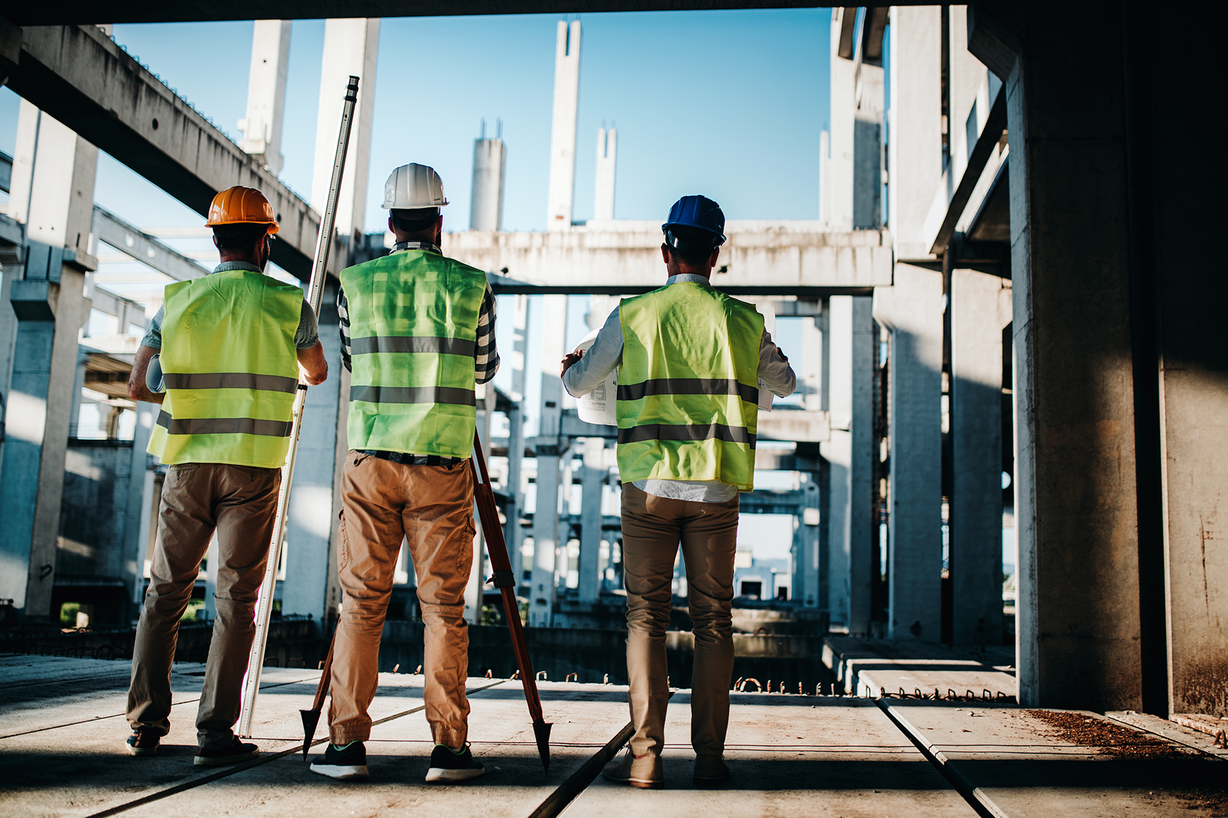 construction engineers and architects discussing the design/build plans at a construction build site