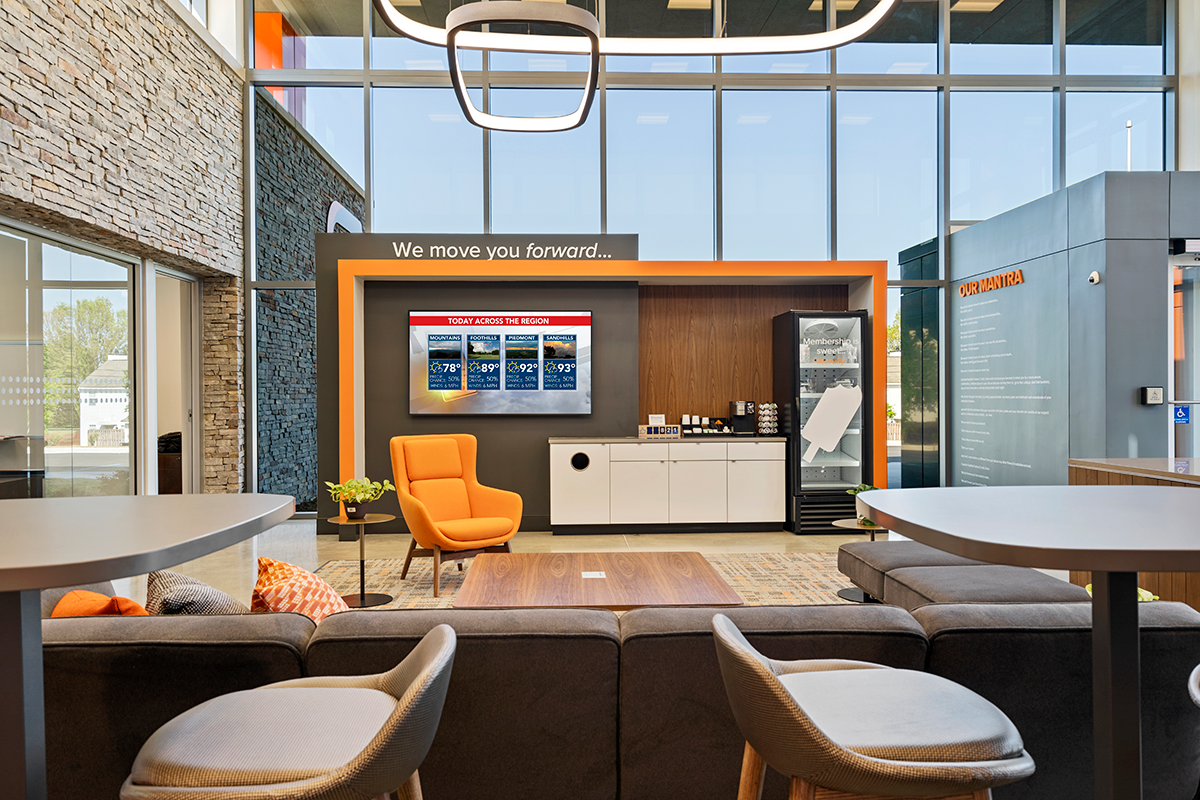 branded entryway to building, with seating areas, and colorful accents throughout the room