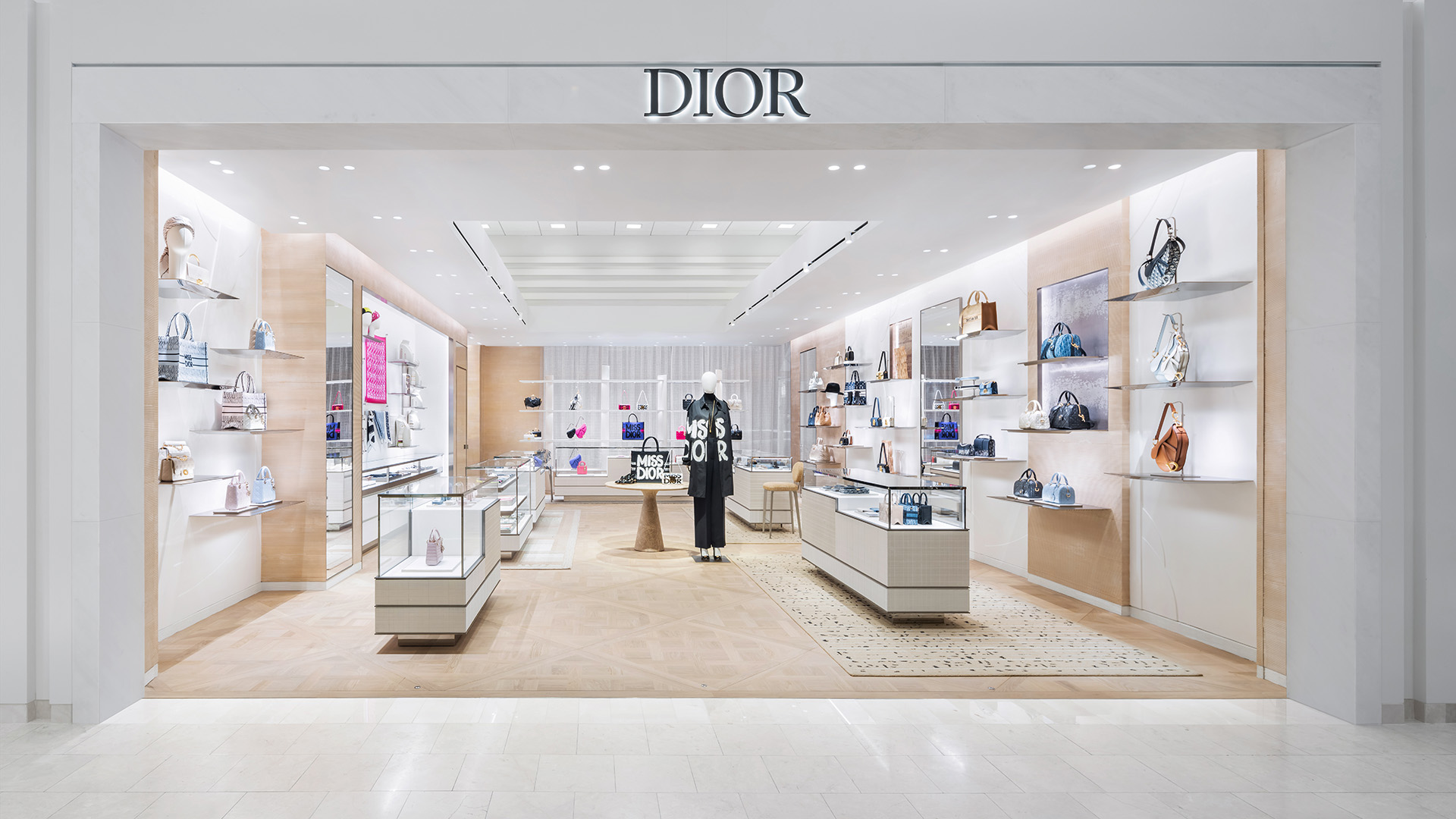 Dior showroom with display cases, shelves on the walls, and rugs